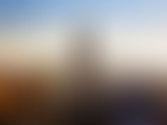 New York City skyline at sunrise, with the Empire State Building prominently in the centre surrounded by other skyscrapers under a clear sky.