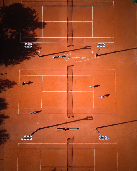 Aerial view of multiple clay tennis courts
