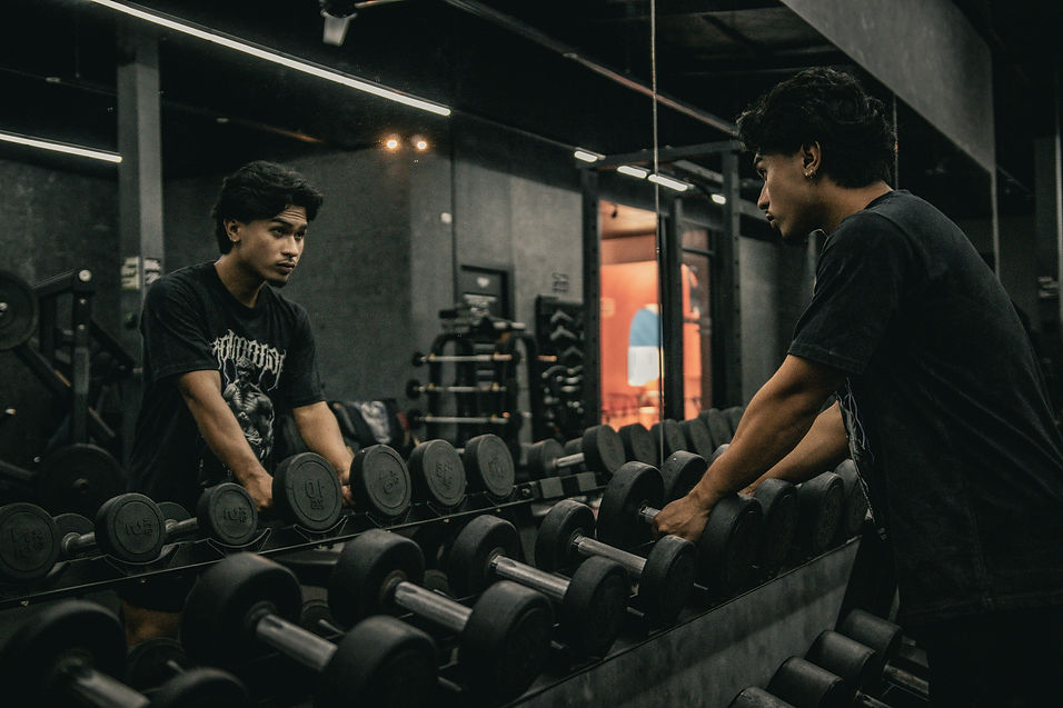 Rows of gym benches in dark lighting – representing commitment, grind, and body transformation.