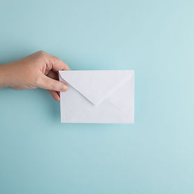 Image of a hand holding an envelop of promotions