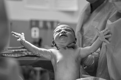 Doctor holding newborn baby
