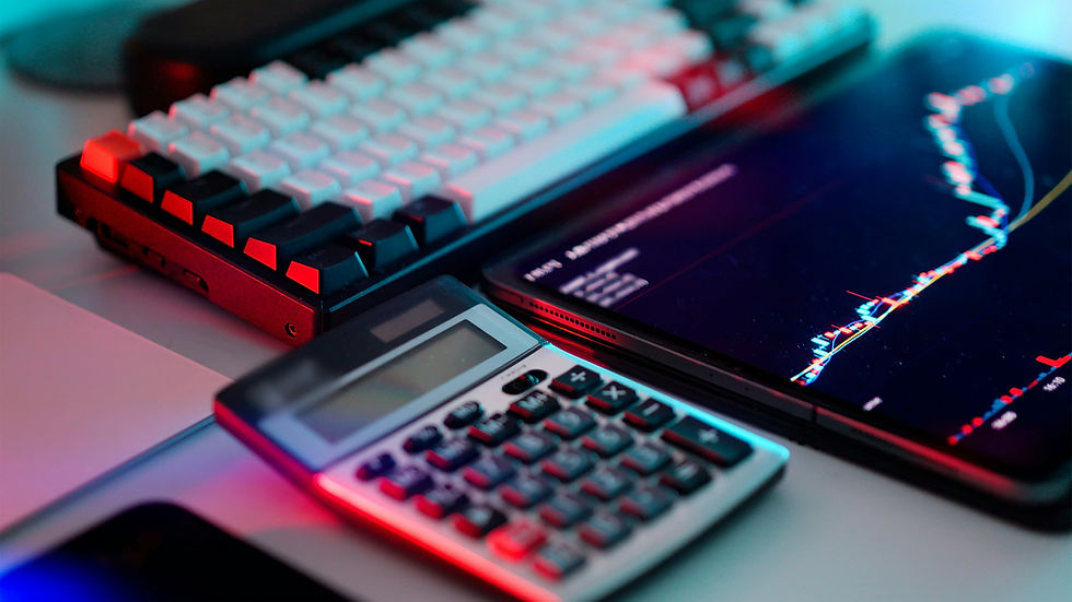 A sleek setup featuring a mechanical keyboard, calculator, and tablet displaying a financial chart, capturing the essence of a modern trading workstation.