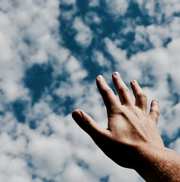 Hand Reaching to the sky and ozone layer