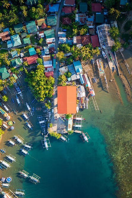 Orange hut and boats by the shore in the Philippines by Jules Bassoleil