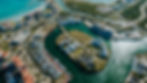 Scenic aerial shot of a sprawling Cap Cana resort with ocean views and well-maintained gardens