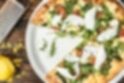 Vegetarian pizze on a plate with one piece missing Image by Brenan Greene