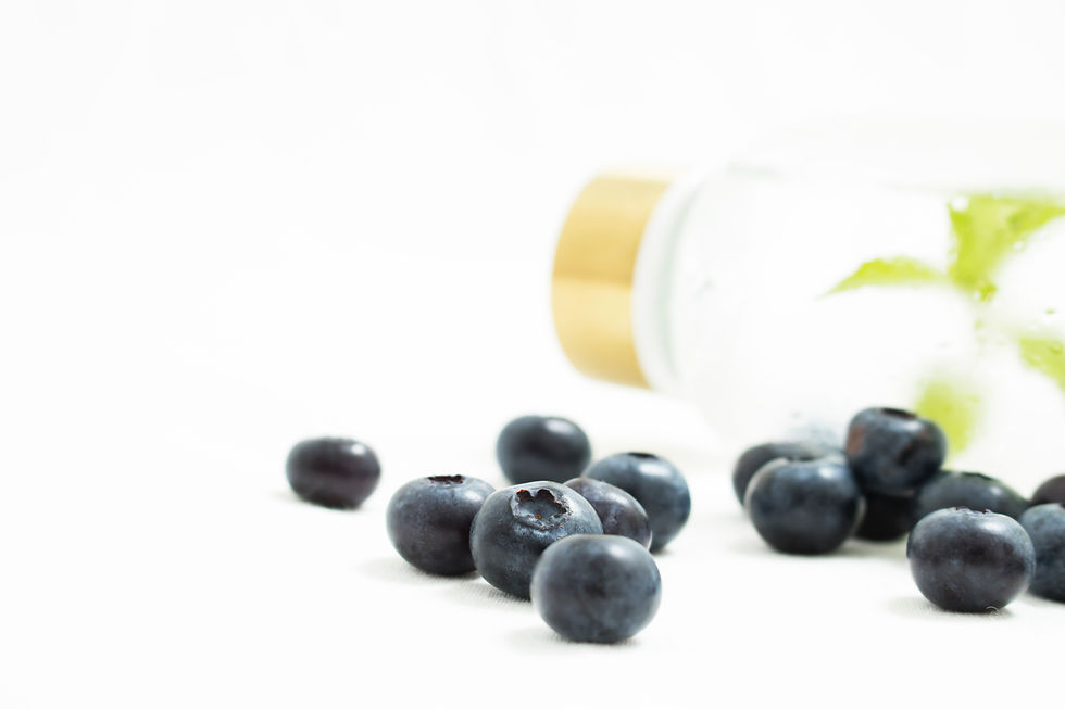 Water bottle with herbs inside and blueberries, nutrition tips for cancer treatment