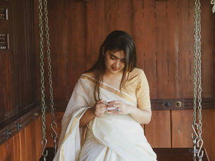an Indian woman wearing a white cotton saree