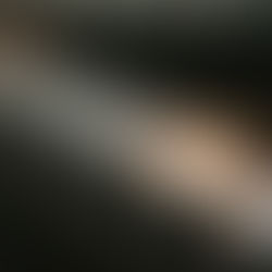 A row of frosted glass votive candles, one lit, creating a warm glow in a dim setting. The mood is serene and contemplative.