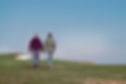 Male Couple walking along a cliff top