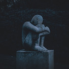 A crying statue representing grief, loss, depression, low mood, shame, guilt, regrets and letting go