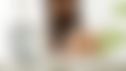 A woman in her 40s sitting quietly in soft natural light with a thoughtful expression, representing the experience of perimenopause heavy periods and the hormonal changes of the menopausal transition from Vibrance Way