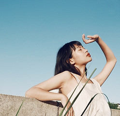 an asian woman looking onto the sky