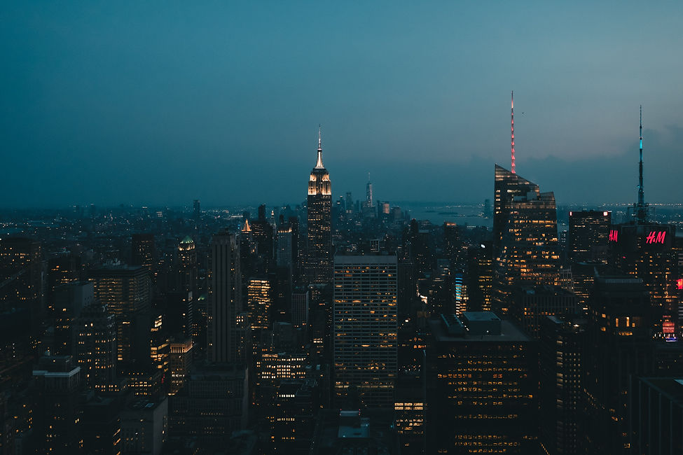 New York City skyline at dusk featuring the Empire State Building, symbolizing innovation, premium technology, luxury, and global lifestyle.