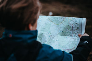 someone reading a map, map reading, navigation training