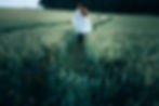 woman walking in a corn field