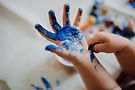 Upendi therapy Services child hand with blue paint