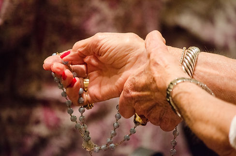 Image by Christopher Rigg, woman's hands holding a rosarys