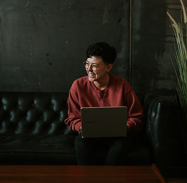 Lady laughing on laptop happy working dark imageon Service Menu Fizzin Digital Marketing