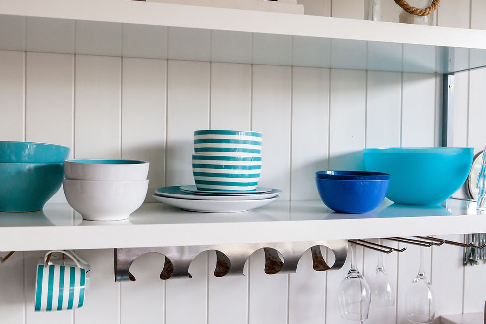 White open shelves with blue bowls and plates on top