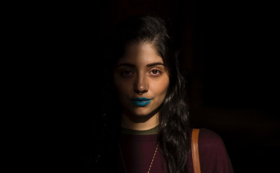 Woman in shadows with blue lipstick