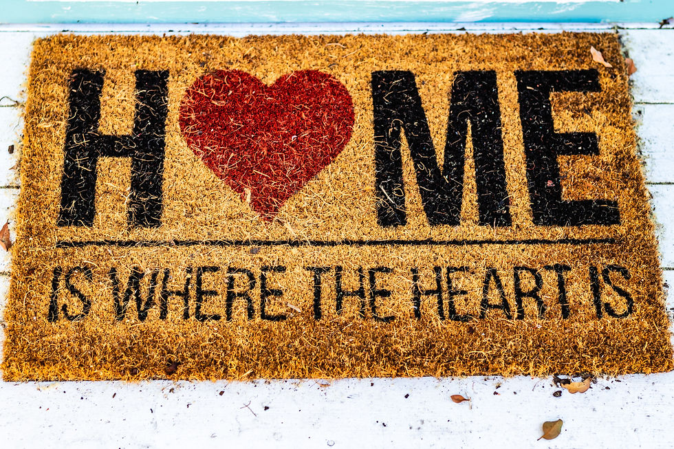 A doormat with the words HOME IS WHERE THE HEART IS.