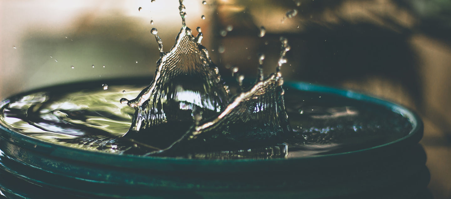 A close-up of water being poured into a bottle, symbolising the crucial role of hydration for health and performance.