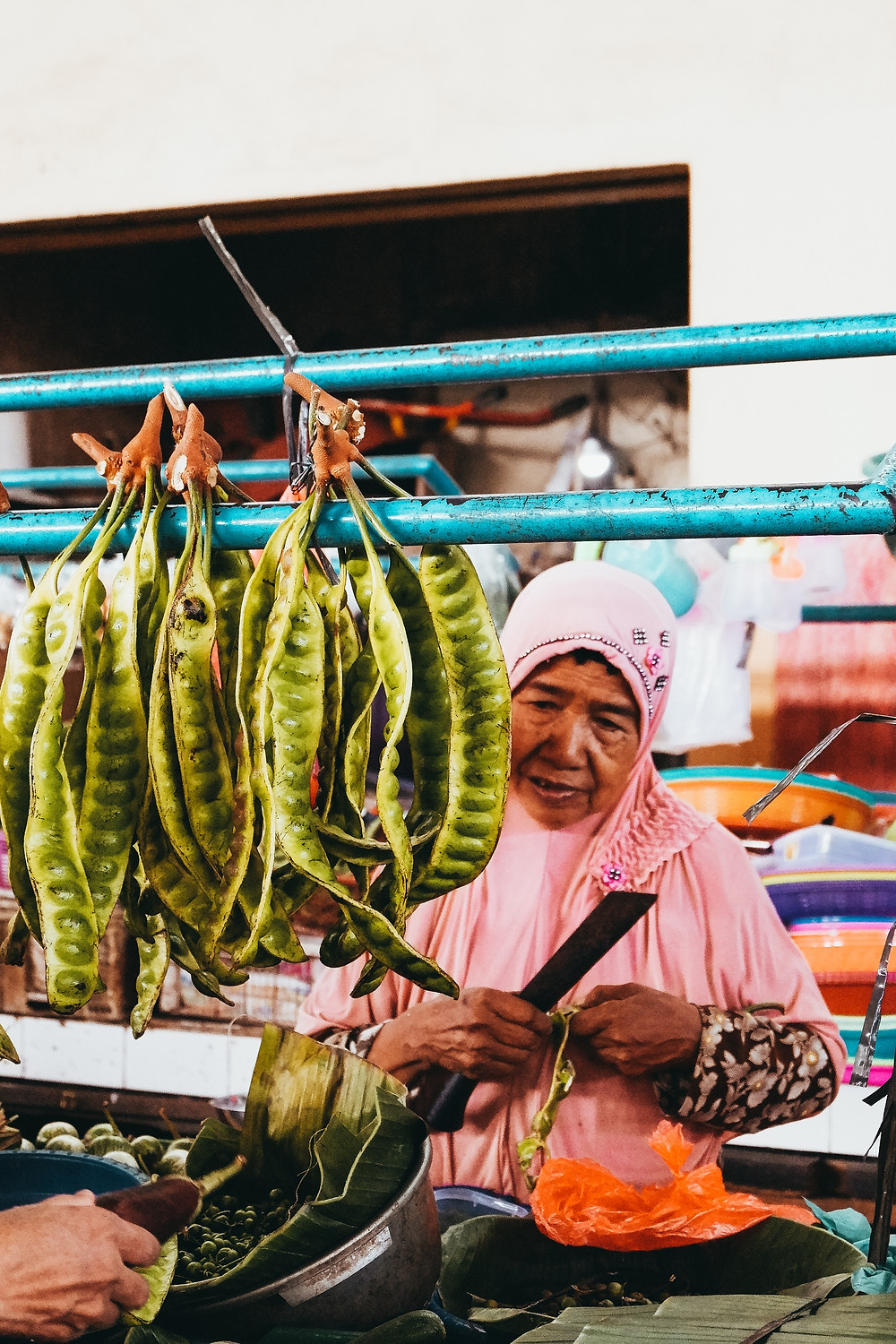 Peteh (pete or petai in Indonesian) beans in strings at a food market in Indonesia