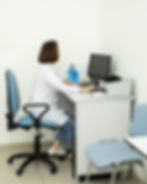 A medical secretary working on her computer