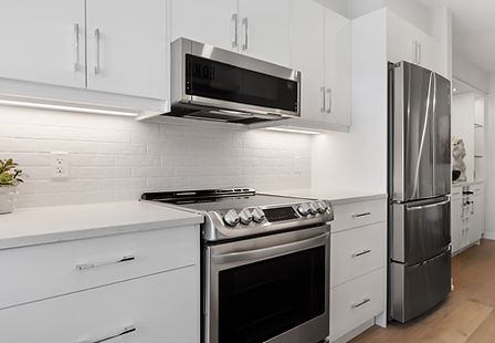 Modern kitchen with white cabinets, a stainless steel oven