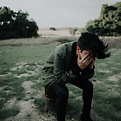 man sad near water