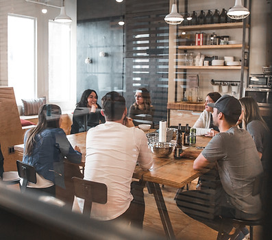 Group of people sitting around a table having a meeting