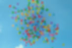 baloons scatter in blue sky