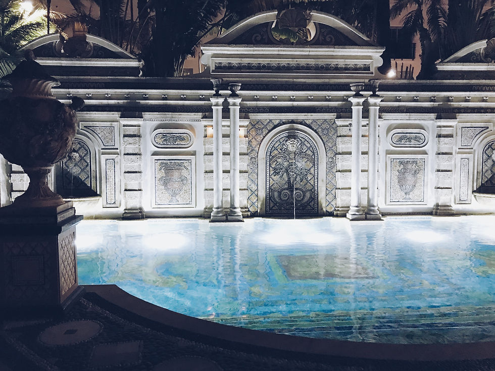 Pool at night with lights and greek columns
