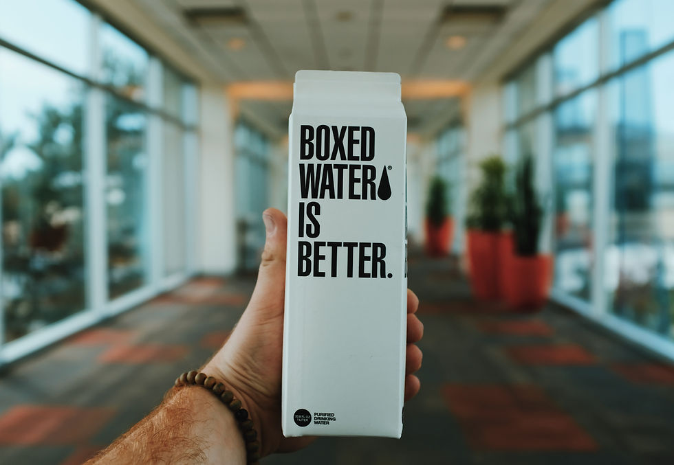 A milk carton being held in the air.
