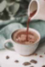 hot chocolate being poured into a mug