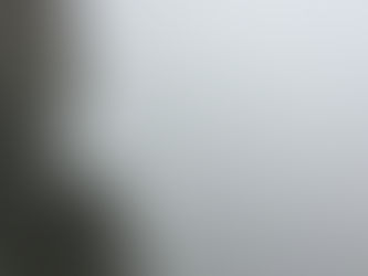 Lone figure on a cliff with misty background