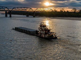 Barge on the river at sunset