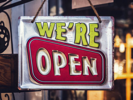 Open sign in front window of a store.