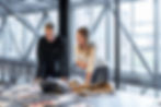 Two B2B go-to-market professionals reviewing sales compensation data at a modern Toronto office, discussing VP of Sales OTE benchmarks in Canada.
