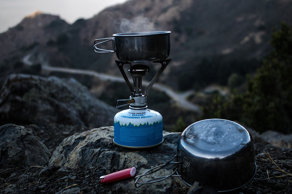 backpacking stove setup with mountain views