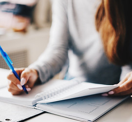 woman writing in a planner
