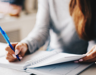 woman writing in a planner