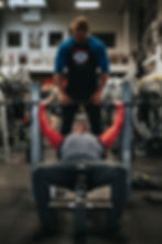 Strong and fit man doing incline barbell bench press to build strength and muscle in his chest, shoulders and triceps