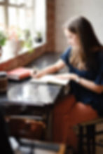 Woman sitting at a desk reflecting