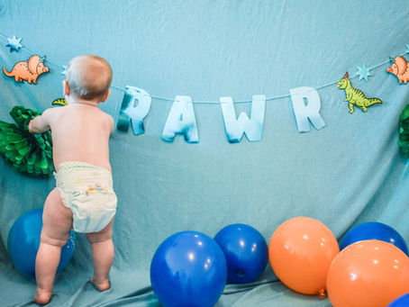 baby in diaper with balloons