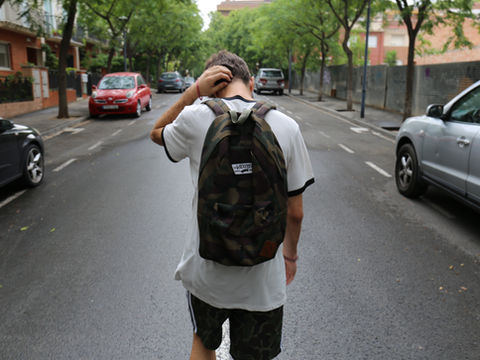 Distressed teen walking through the road