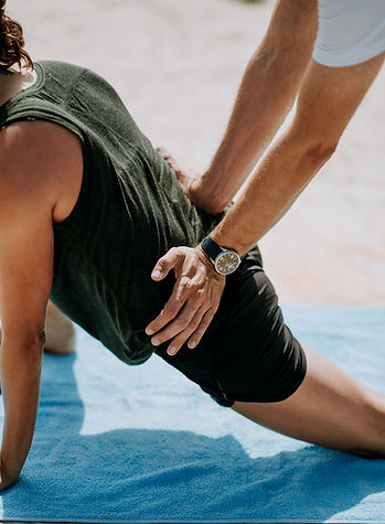 Man doing hip stretch exercise with help of a Chiropractor