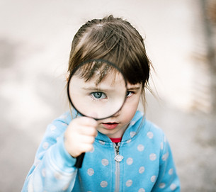 Girl exploring with magnifying glass