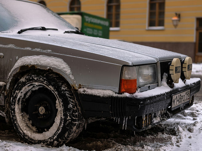 Car covered in snow and road salt during Delta BC winter showing buildup on wheels and lower panels